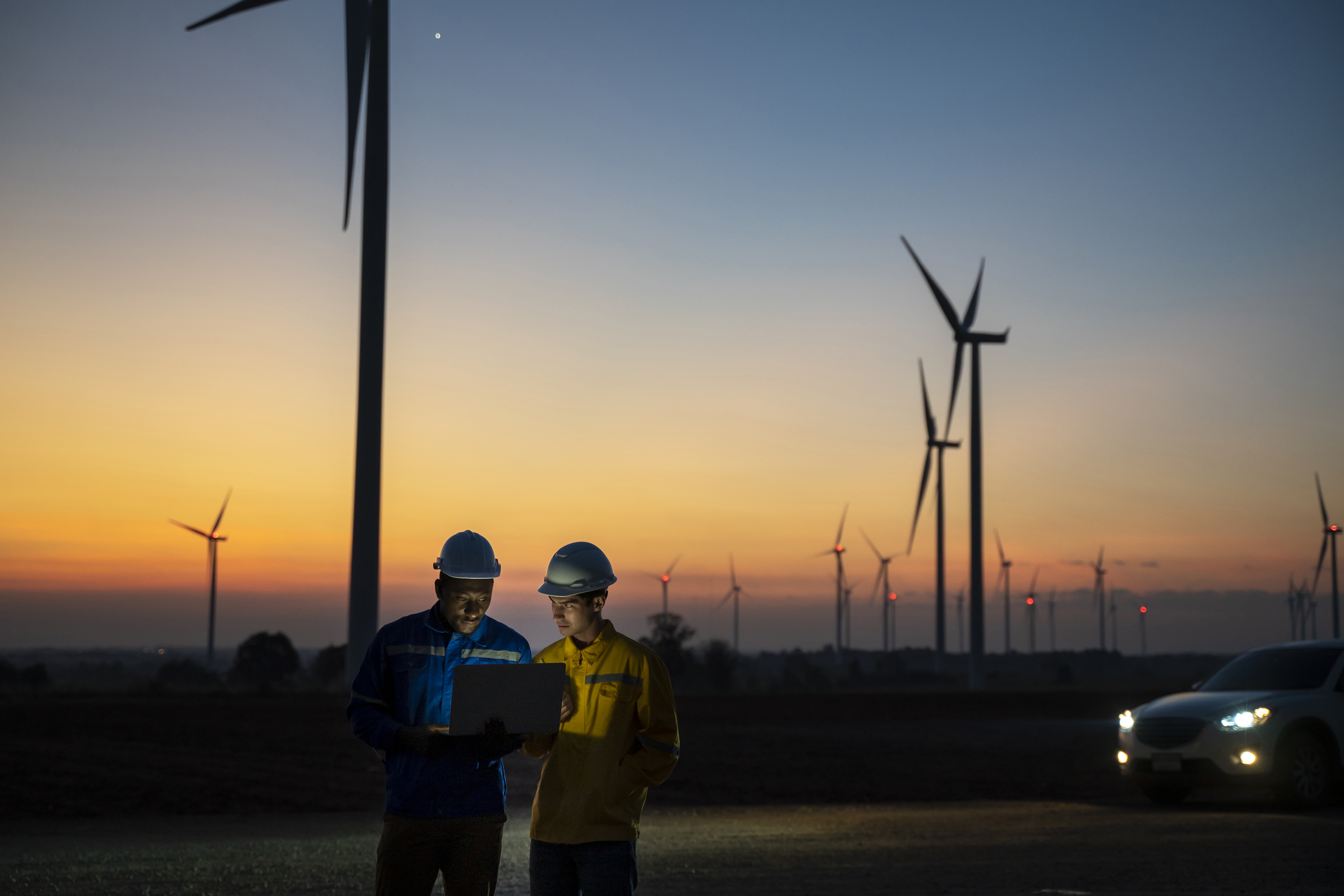Two Electric engineer working at wind turbine farm